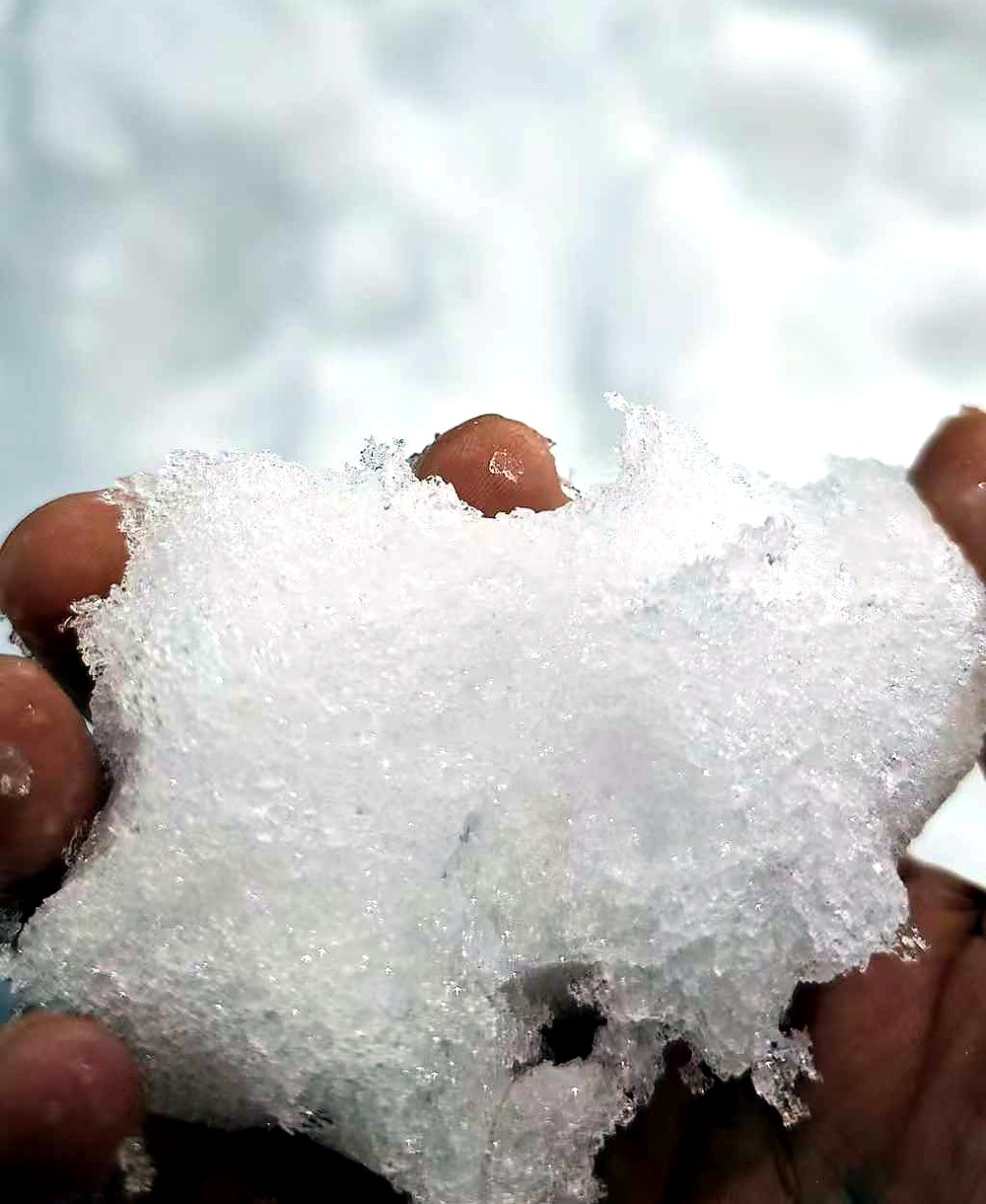 Primer plano de nieve artificial seca y esponjosa obtenida mediante cristalización de agua sobreenfriada